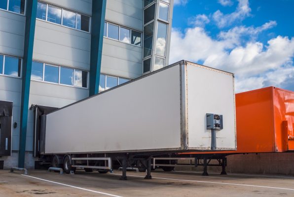 Two truck trailers loading at logistic warehouse distribution centre